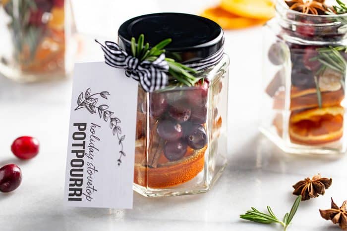 Stovetop potpourri ready for gifting in a glass jar with a gift tag