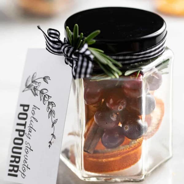Stovetop potpourri in a glass jar with a gift tag tied to it