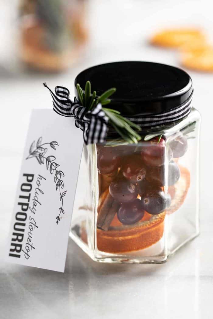 Stovetop potpourri in a glass jar with a gift tag tied to it