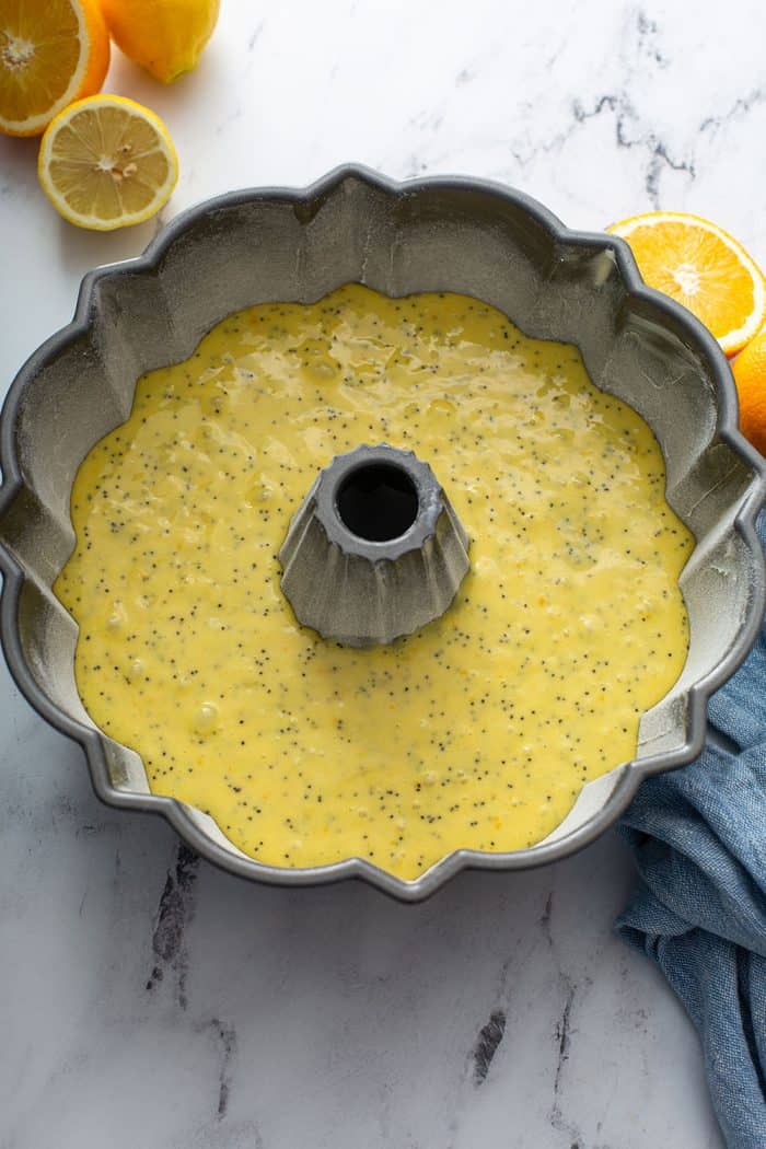 Unbaked citrus poppy seed cake in a bundt pan
