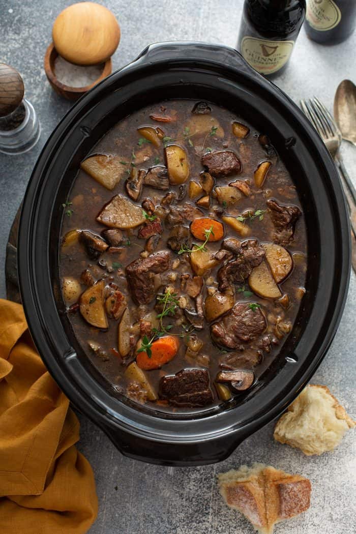 Overhead view of cooked beef and barley stew in a slow cooker