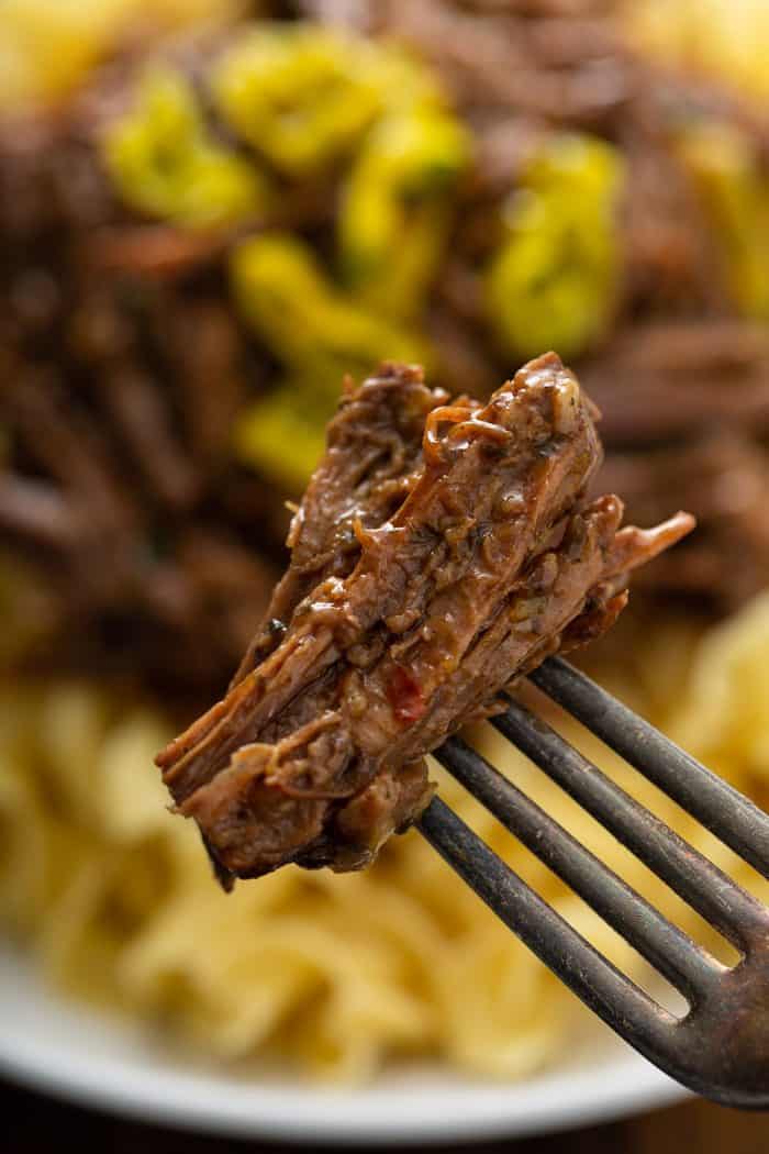 Fork holding up a bite of Mississippi pot roast