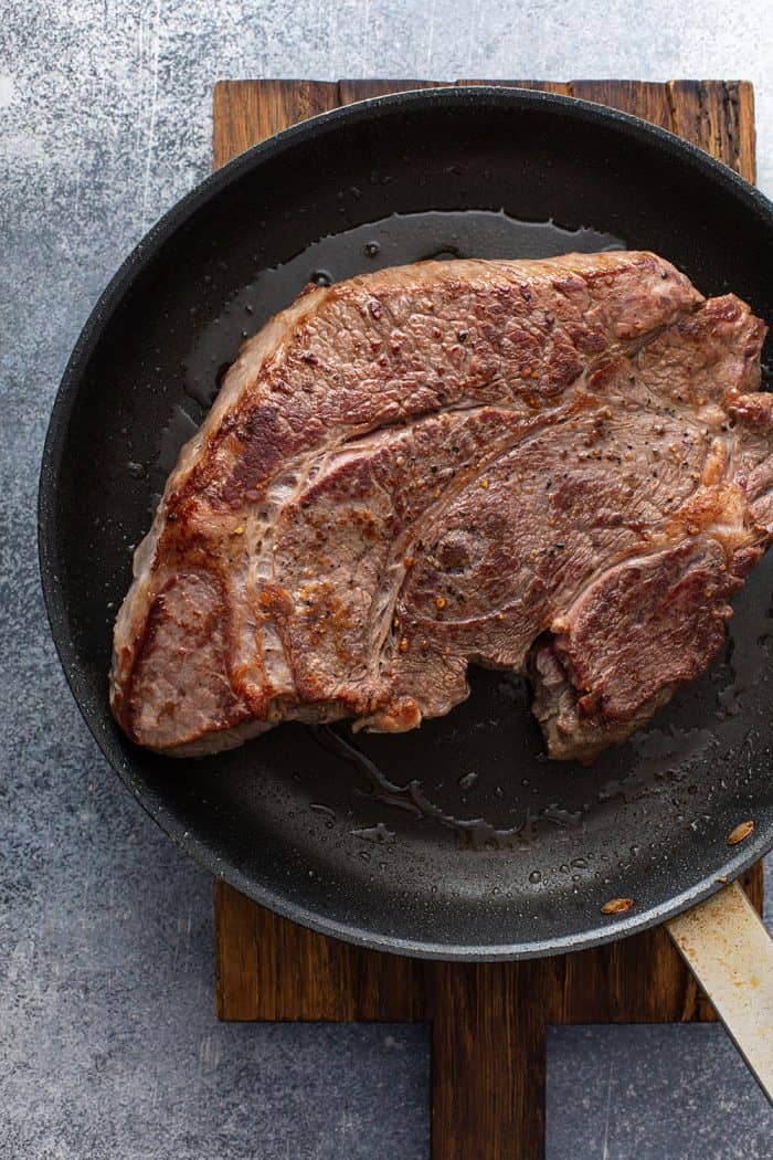 Browned chuck roast in an iron skillet