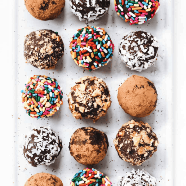 Easy homemade truffles with different coatings arranged on a white platter