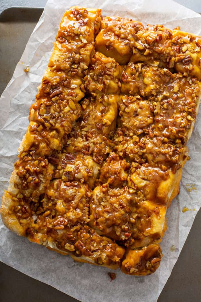 Pecan sticky buns inverted onto a piece of parchment paper