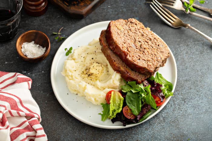 Plated easy meatloaf with mashed potatoes and green salad