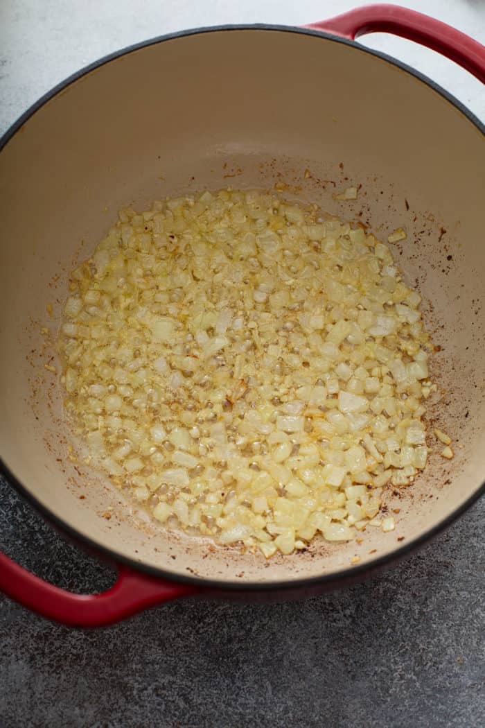 Onions and garlic sauteed in a large dutch oven