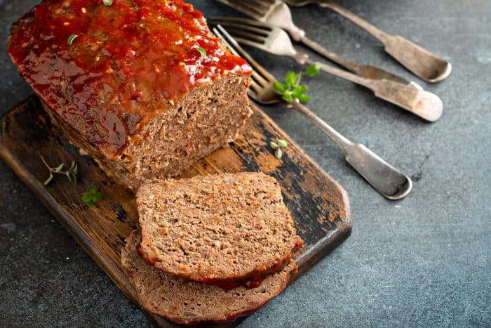 Sliced Easy Meatloaf on a wooden cutting board