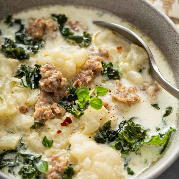Close up of low carb zuppa toscana in a bowl with a spoon