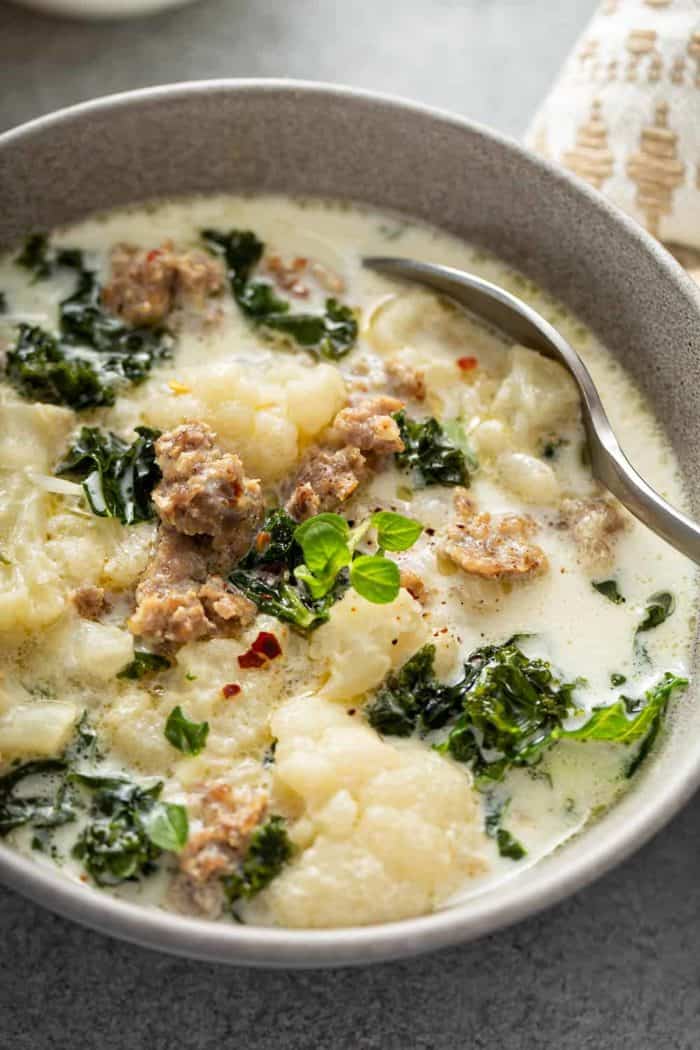 Close up of low carb zuppa toscana in a bowl with a spoon