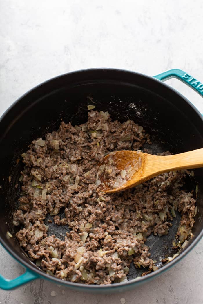 Cooked ground beef, onions and garlic in a cast iron dutch oven