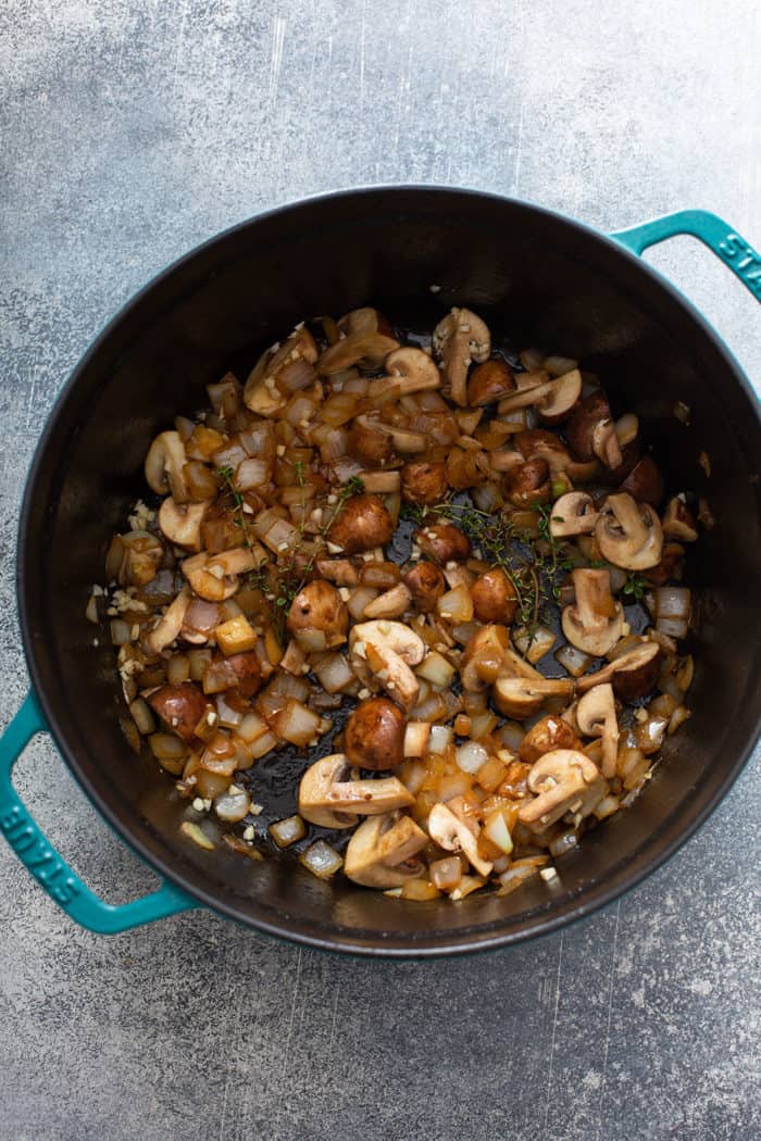 Onions and mushrooms sauteed in a large dutch oven