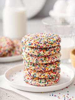 6 funfetti cookies stacked on a white plate