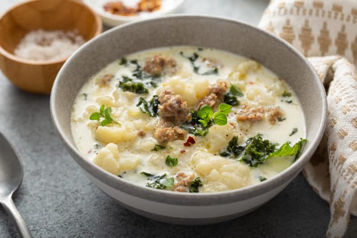 Bowl of low carb zuppa toscana on a gray countertop