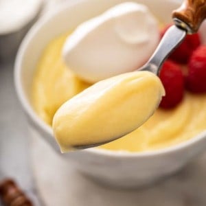 Spoonful of vanilla pudding being held up to the camera