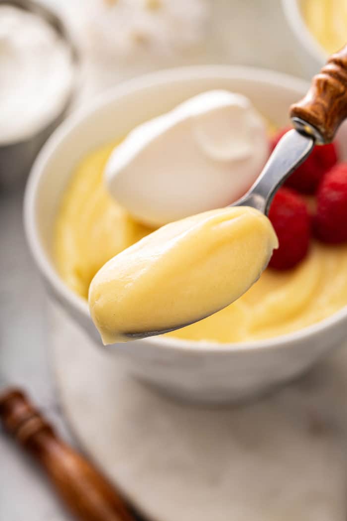 Spoonful of vanilla pudding being held up to the camera