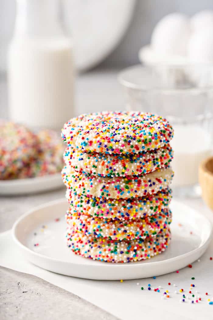 Six funfetti cookies stacked on a white plate