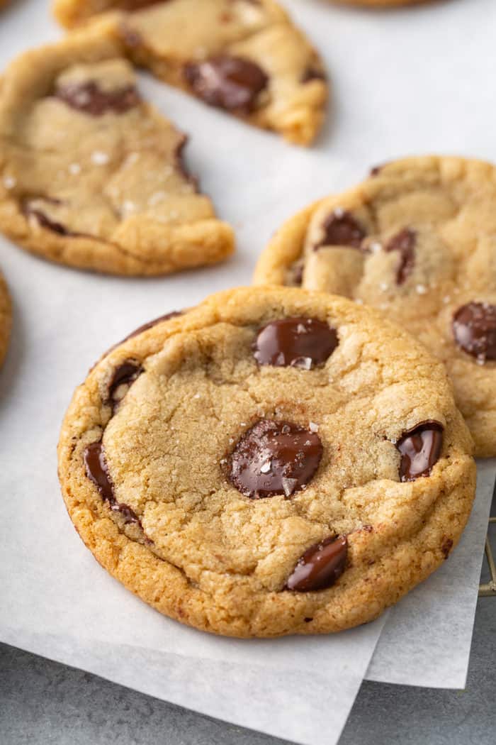 Close up of a brown butter chocolate chip cookie on a piece of parchment paper