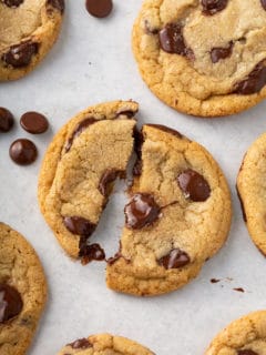 Brown butter chocolate chip cookie broken in half to show the gooey melted chocolate chips