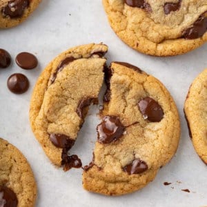 Brown butter chocolate chip cookie broken in half to show the gooey melted chocolate chips