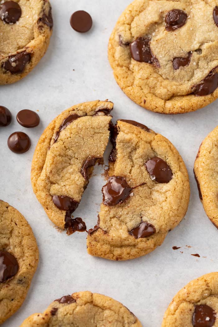 Brown butter chocolate chip cookie broken in half to show the gooey melted chocolate chips