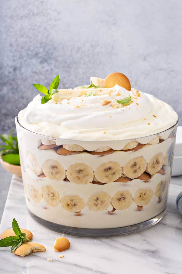 Side view of Magnolia Banana Pudding assembled in a trifle dish, topped with whipped cream 