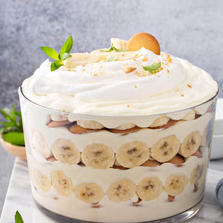 Side view of Magnolia Banana Pudding assembled in a trifle dish, topped with whipped cream