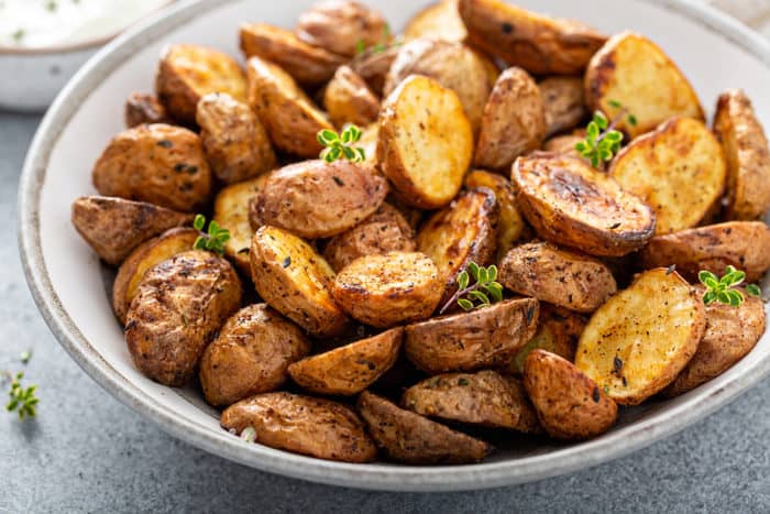 Roasted air fryer potatoes in a white serving bowl