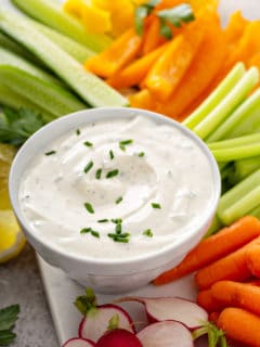 Bowl of ranch dip nestled among cut veggie sticks