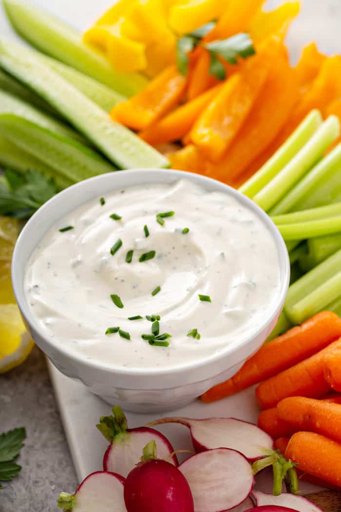 Bowl of ranch dip nestled among cut veggie sticks