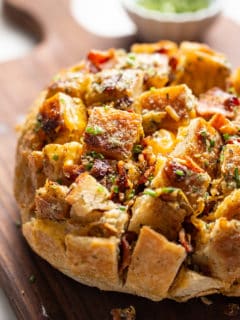 Close up of cheesy ranch pull-apart bread on a cutting board