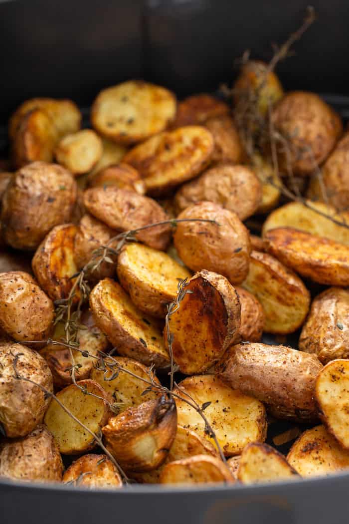 Freshly roasted air fryer potatoes in an air fryer basket