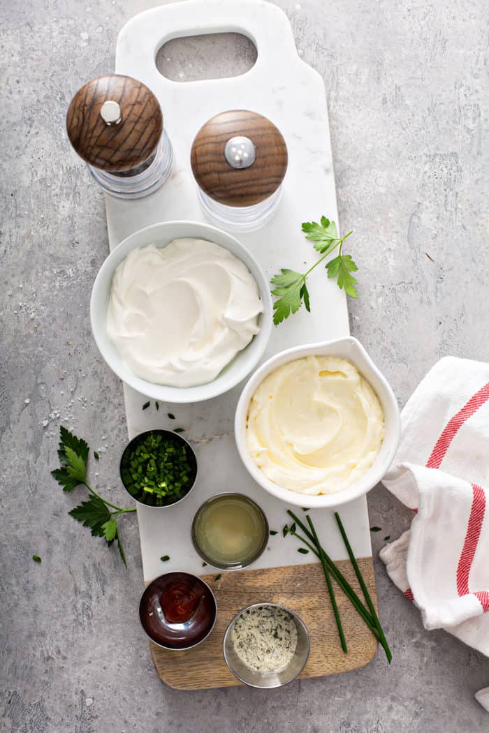 Ingredients for homemade ranch dip arranged on a gray countertop