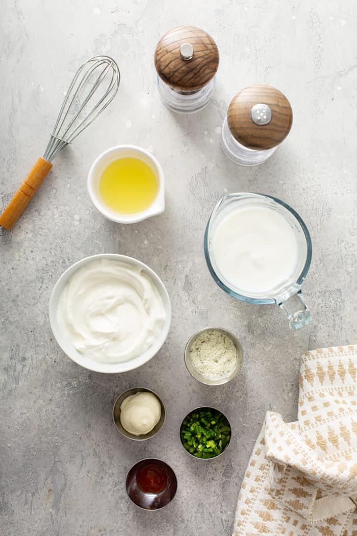 ingredients for homemade ranch dressing arranged on a gray countertop