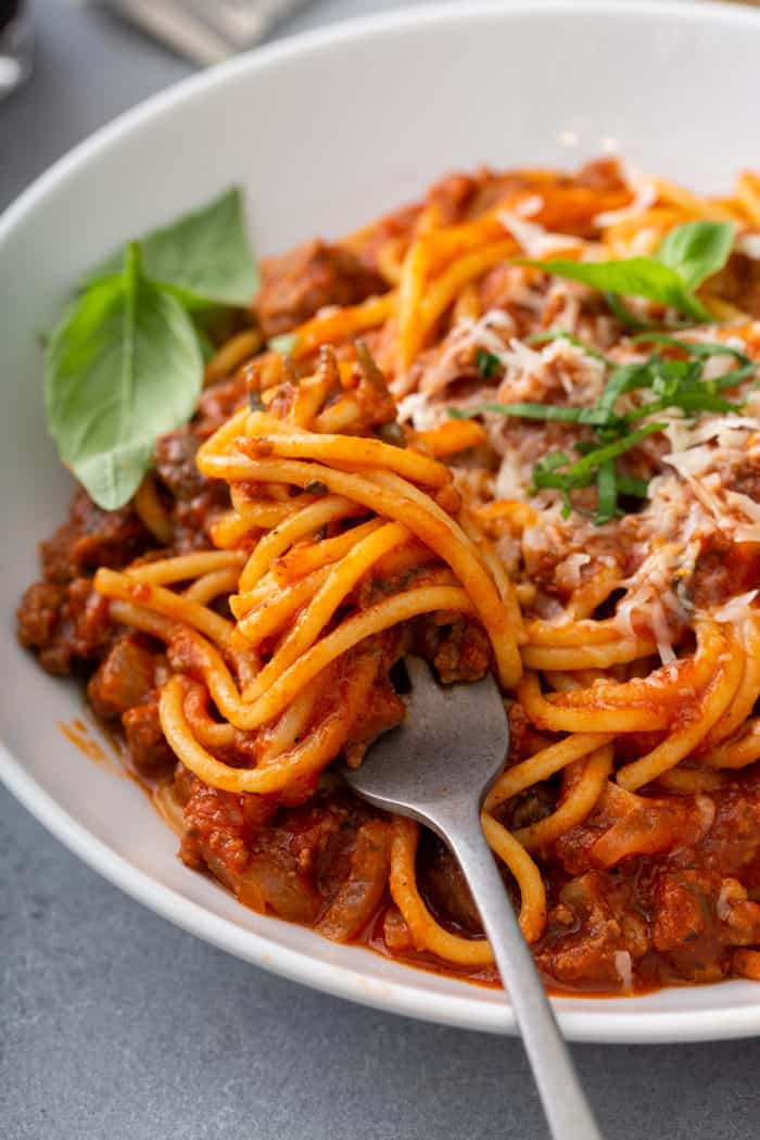 Fork grabbing a bite of one-pot spaghetti from a bowl