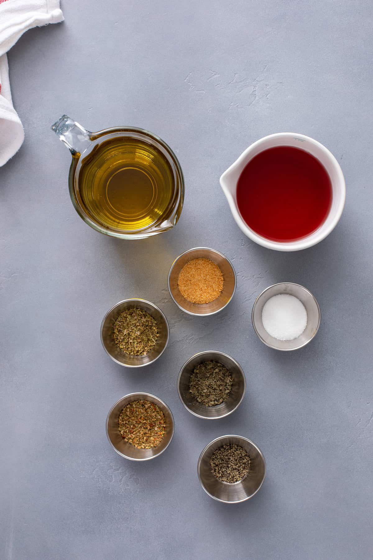 Ingredients for greek salad dressing arranged on a countertop.