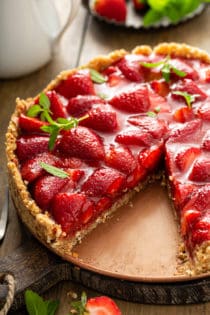 Fresh strawberry pie with a slice cut out of it
