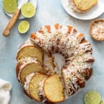 Sliced lime coconut cake surrounded by sliced limes