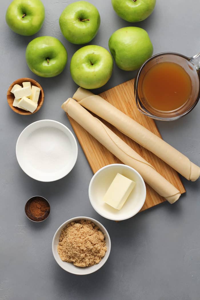 Ingredients for old-fashioned apple dumplings arranged on a gray countertop