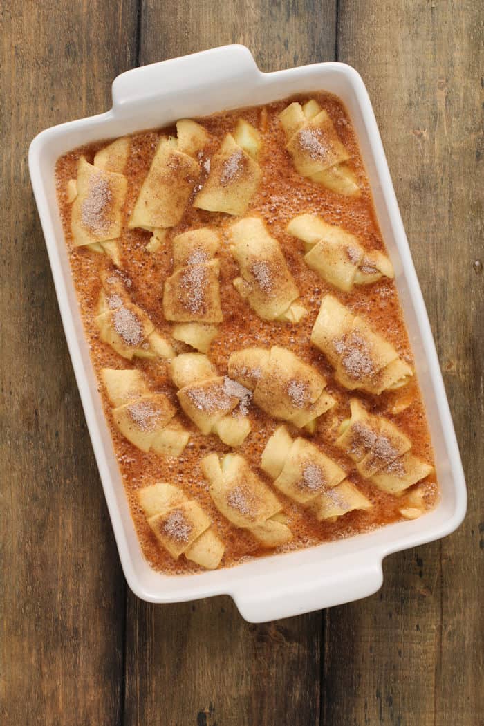 Easy apple dumplings in a white baking dish, ready to be baked