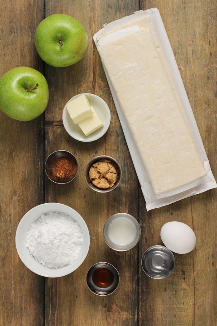 Apple turnover ingredients arranged on a wooden countertop