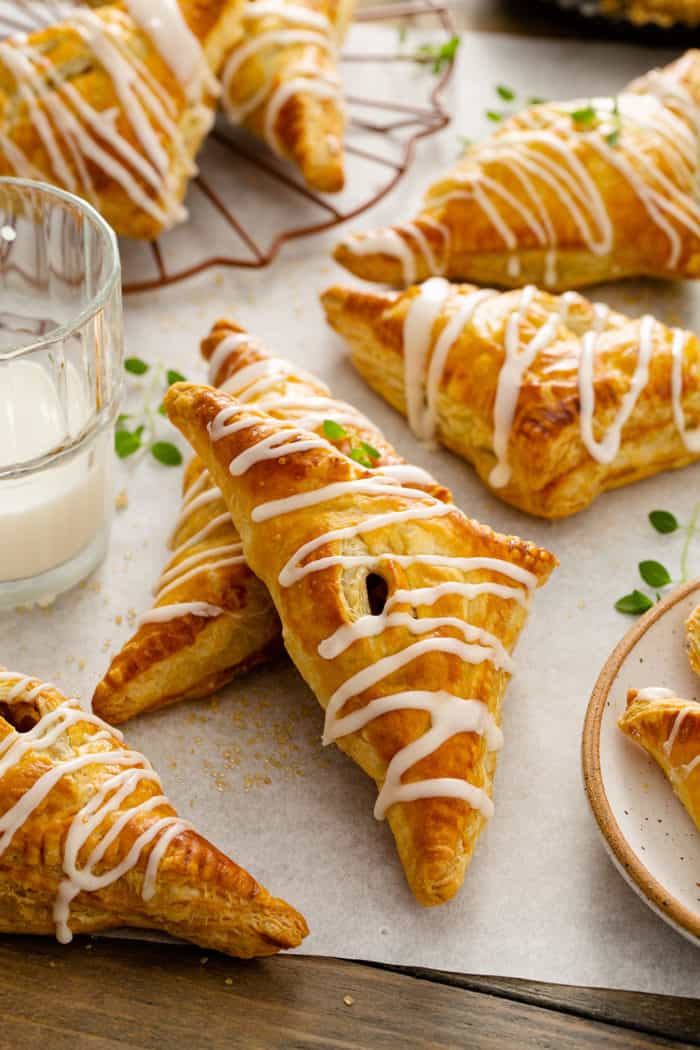 Baked apple turnovers on a piece of parchment paper