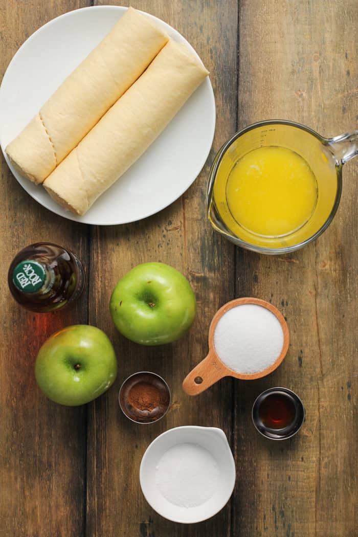 Ingredients for easy apple dumplings arranged on a wooden countertop