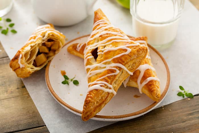 Plated Apple Turnovers next to a glass of milk