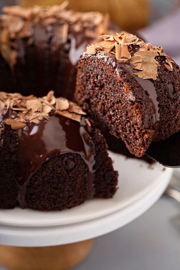 Slice of easy chocolate bundt cake being removed from the cake