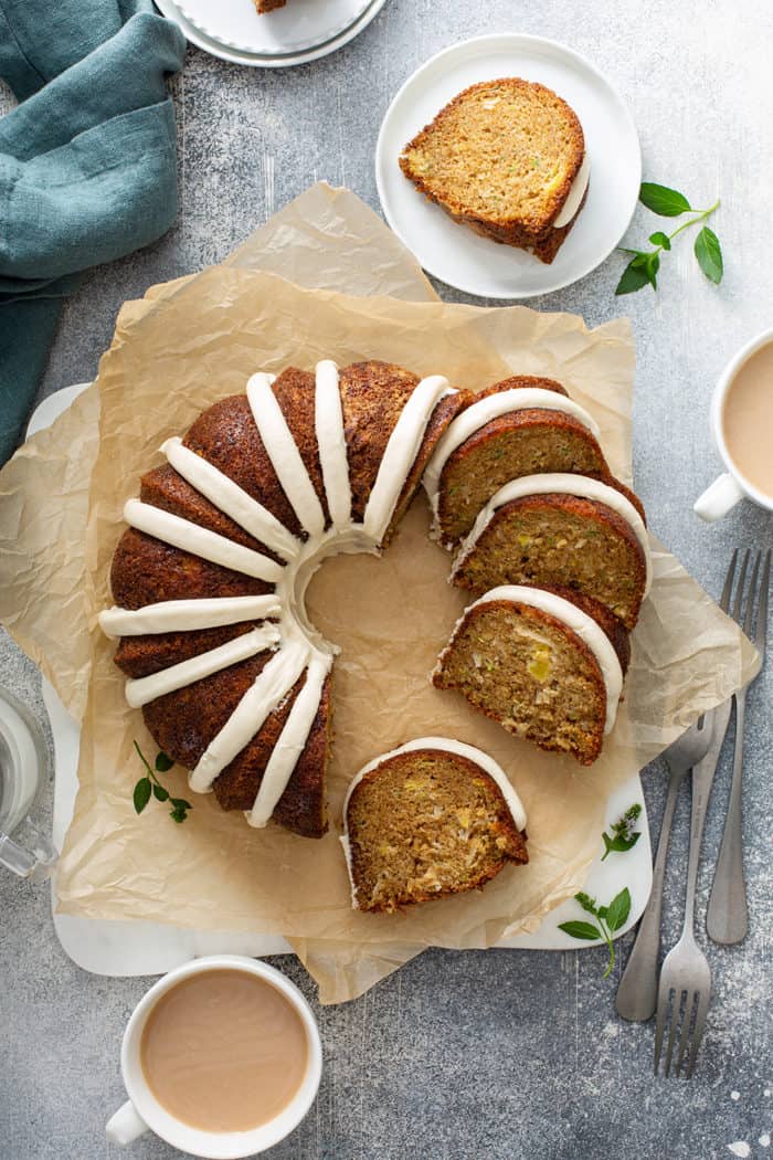 Overhead view of sliced zucchini bundt cake on a slice of parchment paper