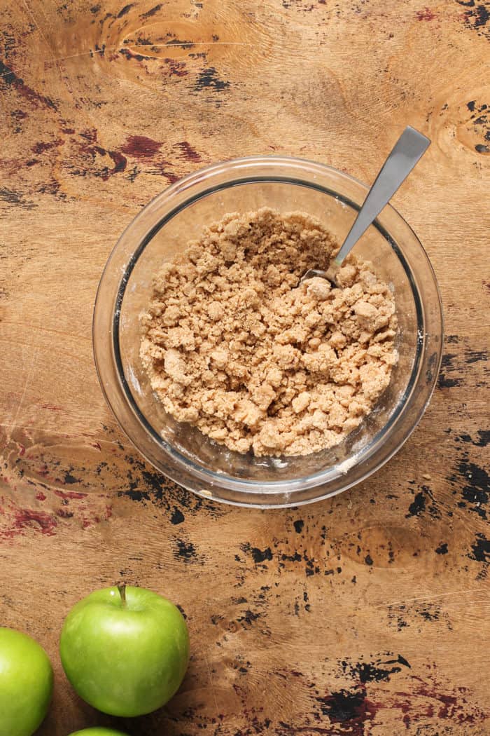 Crumble for apple coffee cake in a glass mixing bowl