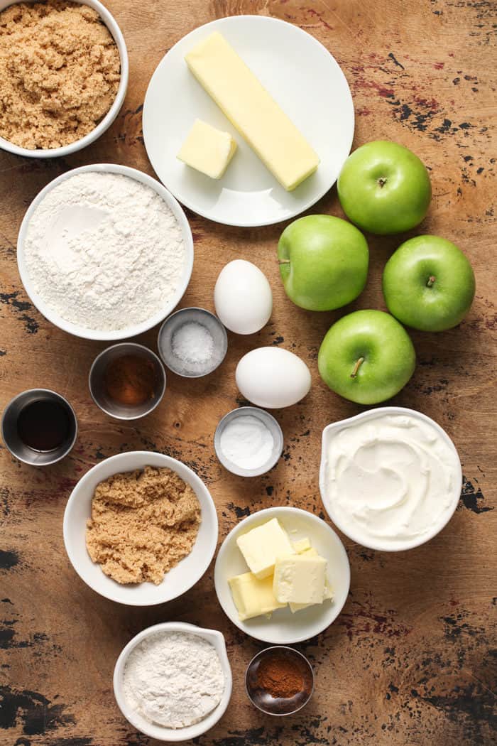 Ingredients for apple coffee cake arranged on a wooden countertop