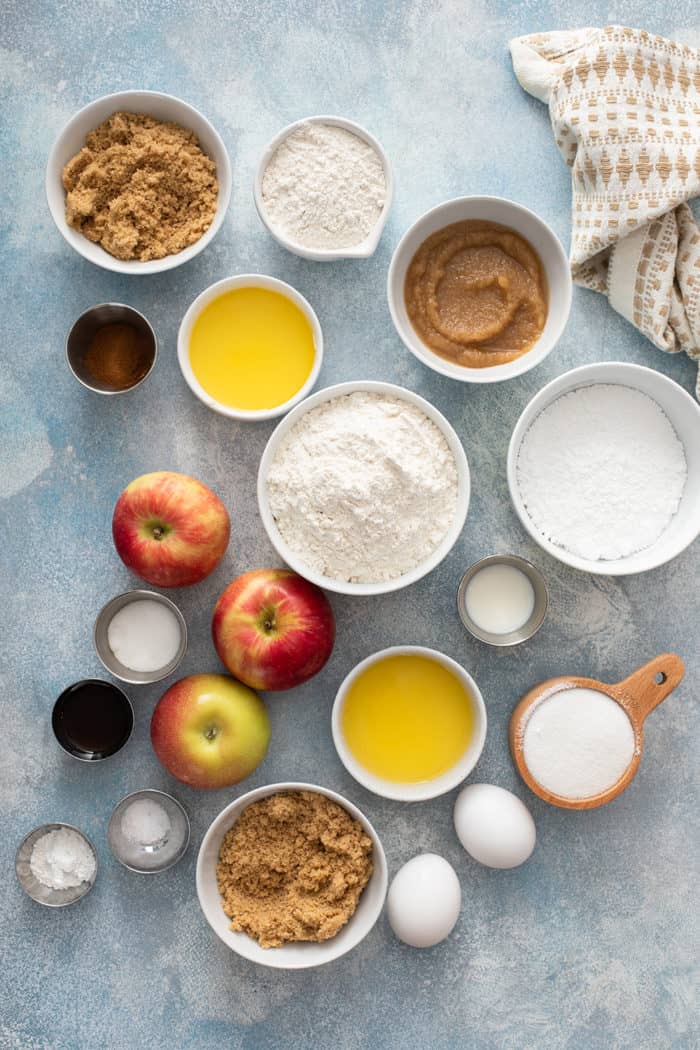 Apple fritter bread ingredients arranged on a blue countertop