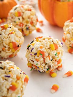 Close up of Halloween popcorn balls scattered on a marble countertop